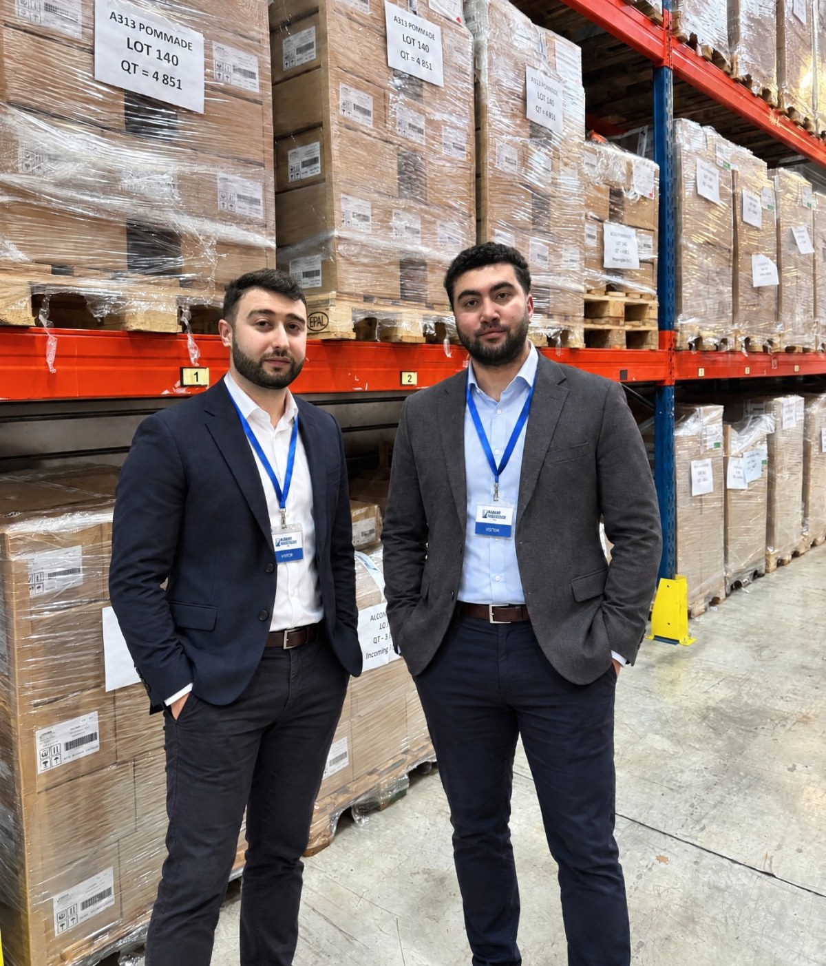 Onik and Gevor Kadian next to pallets of A313 at the manufacturer's warehouse in France